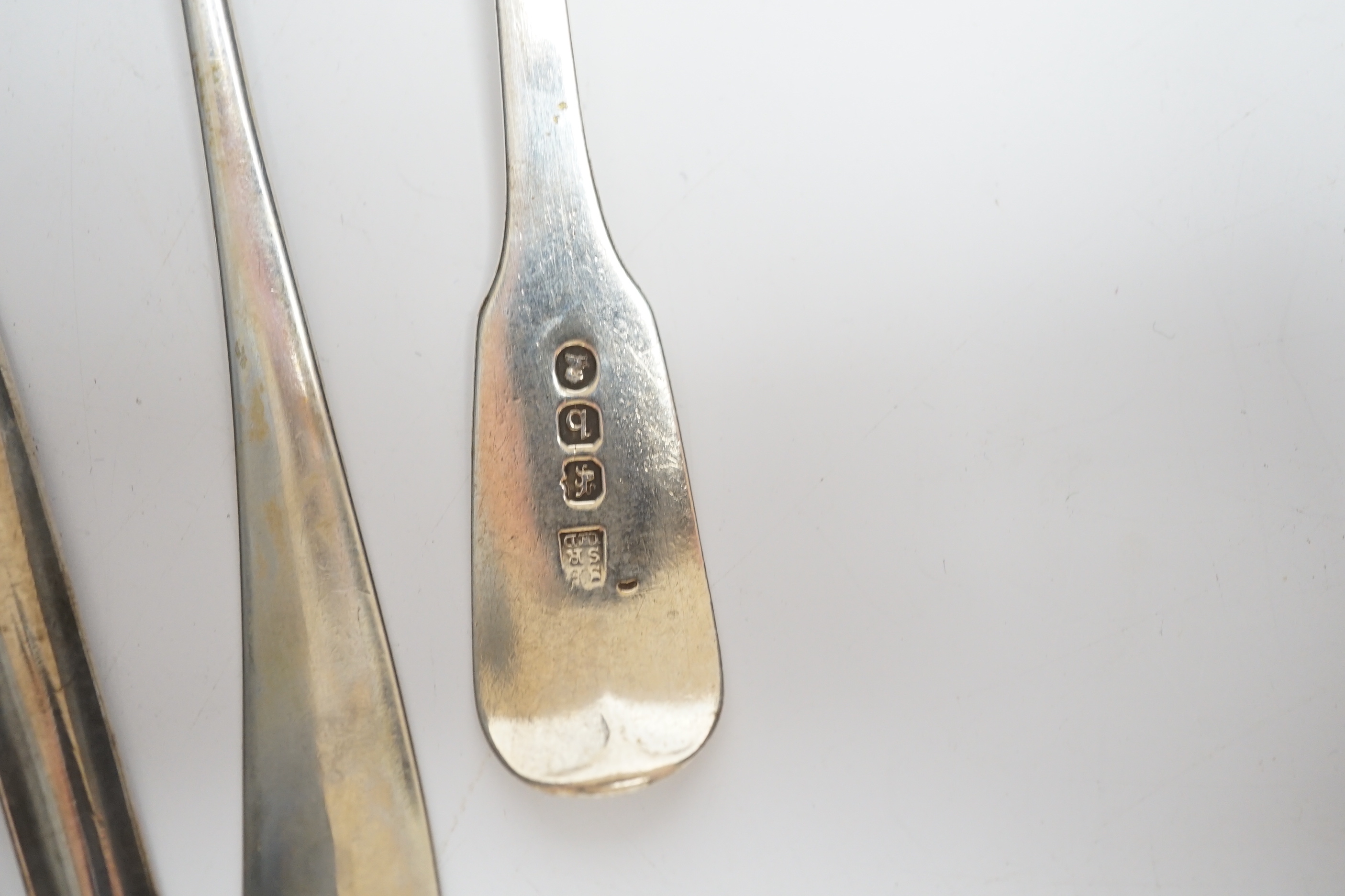 An 18th century silver spoon with marrow scoop handle, indistinct base marks, two silver sifter spoons and a white metal sauce ladle.